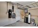 This garage features storage systems, a water heater, and water softener at 5239 Tartan Hill Ave, Las Vegas, NV 89141