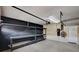 The garage has storage shelves, a work table and room for parking at 5239 Tartan Hill Ave, Las Vegas, NV 89141