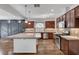 Modern kitchen with granite countertops, stainless steel appliances, and dark wood cabinets at 5239 Tartan Hill Ave, Las Vegas, NV 89141