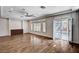 Bright and airy living room with wood floors, large windows, and a sliding door to the backyard at 5239 Tartan Hill Ave, Las Vegas, NV 89141