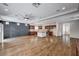 Spacious living room with wood floors, modern design elements, and seamless transition to the gourmet kitchen at 5239 Tartan Hill Ave, Las Vegas, NV 89141