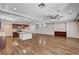 Expansive living area with wood floors, recessed lighting, and open layout connecting to the modern kitchen at 5239 Tartan Hill Ave, Las Vegas, NV 89141