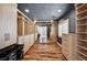 Spacious walk-in closet featuring custom shelving, drawers, wood flooring, and ample storage space at 5239 Tartan Hill Ave, Las Vegas, NV 89141