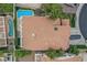 Aerial view of the home featuring a backyard pool, tile roof, mature trees and well maintained landscaping at 53 Grossinger Ct, Henderson, NV 89074
