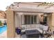 Backyard patio with a stylish outdoor seating area, fireplace, and a view of the refreshing pool at 53 Grossinger Ct, Henderson, NV 89074