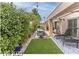 Backyard showing covered patio with furnishings, mature landscaping, and a refreshing in-ground pool at 53 Grossinger Ct, Henderson, NV 89074