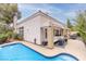 This backyard features a cozy covered patio and a sparkling blue pool for outdoor enjoyment at 53 Grossinger Ct, Henderson, NV 89074