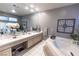 Bright primary bathroom featuring soaking tub, double sink vanity, and an abundance of counter space at 53 Grossinger Ct, Henderson, NV 89074