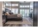 Stylish main bedroom with a ceiling fan, wood floors, many windows, and dark furniture at 53 Grossinger Ct, Henderson, NV 89074