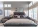 Serene primary bedroom features neutral tones, ample natural light, and a large decorative mirror at 53 Grossinger Ct, Henderson, NV 89074