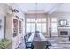 A modern dining area featuring a fireplace, white pillars, and shutters on the windows at 53 Grossinger Ct, Henderson, NV 89074