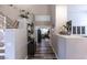 Inviting hallway with decorative accents, stairs, and a view into a comfortably furnished bedroom at 53 Grossinger Ct, Henderson, NV 89074