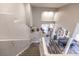 View from the top of the stairs showing a look into the well-lit living room and dining room at 53 Grossinger Ct, Henderson, NV 89074