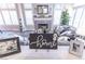 Cozy living room featuring a gray tiled fireplace, modern furniture, and lots of natural light at 53 Grossinger Ct, Henderson, NV 89074