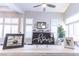 Bright living room with many large windows, plantation shutters, and decor on mantel at 53 Grossinger Ct, Henderson, NV 89074