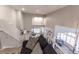 View from the top of the stairs showing a look into the well-lit living room at 53 Grossinger Ct, Henderson, NV 89074