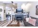 Open-concept living room featuring a cozy fireplace, neutral decor, and wood-style flooring at 53 Grossinger Ct, Henderson, NV 89074