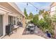 Inviting outdoor patio with a grill, comfortable seating, and charming landscaping at 53 Grossinger Ct, Henderson, NV 89074