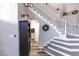 Staircase with white railings and a view of the side entry and laundry room at 53 Grossinger Ct, Henderson, NV 89074