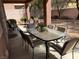 Covered patio with outdoor seating and a lush backyard view at 530 Calahonda Ct, Las Vegas, NV 89138