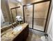 Bathroom featuring granite counters, white vessel sink, decorative faucet, and glass enclosed shower at 530 Calahonda Ct, Las Vegas, NV 89138