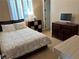 Cozy bedroom with a queen bed, shutters, carpeted floors, dresser, and an end table at 530 Calahonda Ct, Las Vegas, NV 89138
