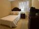 Bedroom with a twin bed, carpeted floors, shutters, dresser, and an end table at 530 Calahonda Ct, Las Vegas, NV 89138