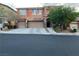 Two story home with a three car garage and mature landscaping in a residential neighborhood at 530 Calahonda Ct, Las Vegas, NV 89138