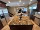 Kitchen features a granite island, stainless steel appliances and dark wood cabinets at 530 Calahonda Ct, Las Vegas, NV 89138