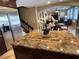 Spacious kitchen with a large island, granite countertops, stainless steel appliances, and access to the living room at 530 Calahonda Ct, Las Vegas, NV 89138
