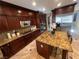 Gourmet kitchen featuring granite countertops, stainless steel appliances, and ample cabinet space at 530 Calahonda Ct, Las Vegas, NV 89138