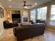 Comfortable living room with a ceiling fan, fireplace and large windows allowing for ample natural light at 530 Calahonda Ct, Las Vegas, NV 89138
