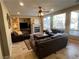 Inviting living room featuring large windows, a fireplace, and comfortable seating with plush leather furniture at 530 Calahonda Ct, Las Vegas, NV 89138