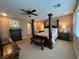 Spacious main bedroom featuring a four-poster bed, ceiling fan, and carpeted floors at 530 Calahonda Ct, Las Vegas, NV 89138