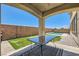 Spacious backyard featuring a covered patio, putting green, and pool for outdoor enjoyment at 5920 Big Horn View St, North Las Vegas, NV 89031