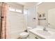 Bright bathroom featuring a shower-tub combo, tile floors and single sink vanity at 5920 Big Horn View St, North Las Vegas, NV 89031