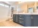 Bathroom featuring a double vanity with blue cabinets, shower, and tile flooring at 5920 Big Horn View St, North Las Vegas, NV 89031