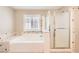 Modern bathroom featuring a separate shower and soaking tub with elegant tile surround and bright lighting at 5920 Big Horn View St, North Las Vegas, NV 89031