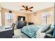 Comfortable bedroom featuring a ceiling fan, desk and dresser with a bright window at 5920 Big Horn View St, North Las Vegas, NV 89031