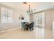 Bright dining area featuring a round table, plantation shutters, and tile flooring at 5920 Big Horn View St, North Las Vegas, NV 89031