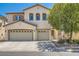 Charming two-story home with a three-car garage, stucco facade, and well-maintained landscaping at 5920 Big Horn View St, North Las Vegas, NV 89031