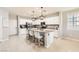 Bright kitchen features an island with seating, stainless steel appliances, and white cabinetry at 5920 Big Horn View St, North Las Vegas, NV 89031