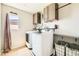 Well-equipped laundry room with modern appliances, shelving, and a decorative laundry sign at 5920 Big Horn View St, North Las Vegas, NV 89031