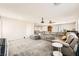 The living room has neutral carpet and paint with a projector at 5920 Big Horn View St, North Las Vegas, NV 89031