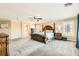 Expansive main bedroom with a decorative bed frame, ceiling fan, plush carpet, and multiple windows at 5920 Big Horn View St, North Las Vegas, NV 89031