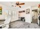 Well-lit office space with a ceiling fan and a sleek white chair, creating a perfect work environment at 5920 Big Horn View St, North Las Vegas, NV 89031