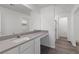 Bathroom featuring a gray countertop, white cabinets and updated fixtures at 6713 Violet Cascade Ave, Las Vegas, NV 89156