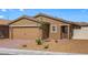 Single story home featuring a two car garage, desert landscaping, and neutral color palette at 6719 Violet Cascade Ave, Las Vegas, NV 89156