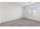 This bedroom features neutral carpet, a window for natural light, and clean, white walls at 6731 Lotus Vista Ct, Las Vegas, NV 89156