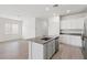 Modern kitchen featuring an island, stainless appliances, white cabinets, and granite countertops at 6731 Lotus Vista Ct, Las Vegas, NV 89156